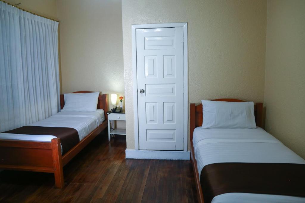 Postel nebo postele na pokoji v ubytování Hostal Loro Verde