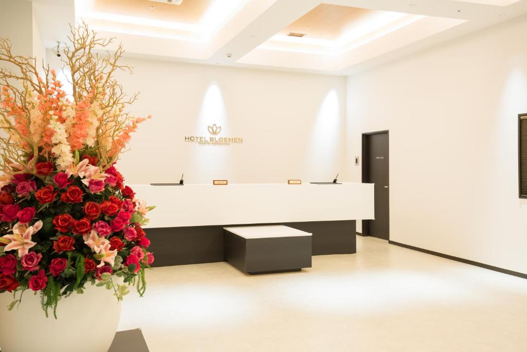 a waiting room with a large bouquet of flowers at Hotel Bloemen North Hanazono in Osaka