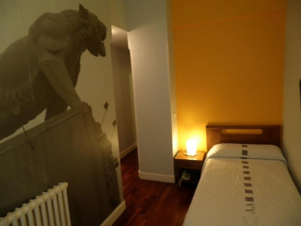Postel nebo postele na pokoji v ubytování Hotel Photo Zabalburu
