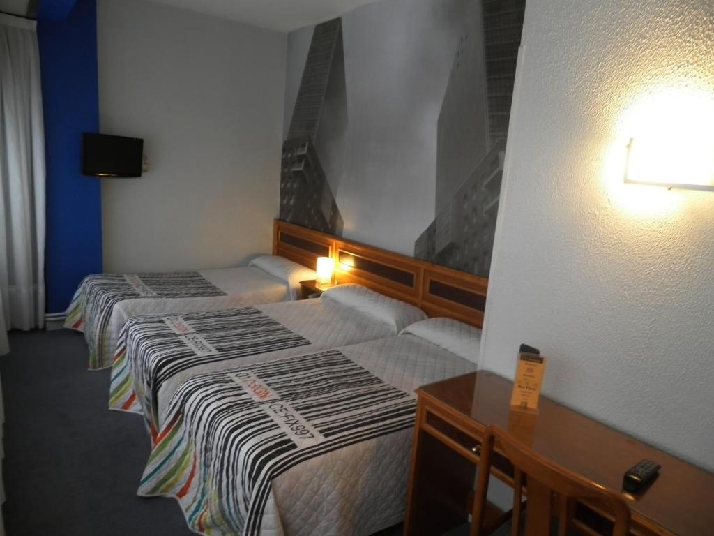 Postel nebo postele na pokoji v ubytování Hotel Photo Zabalburu