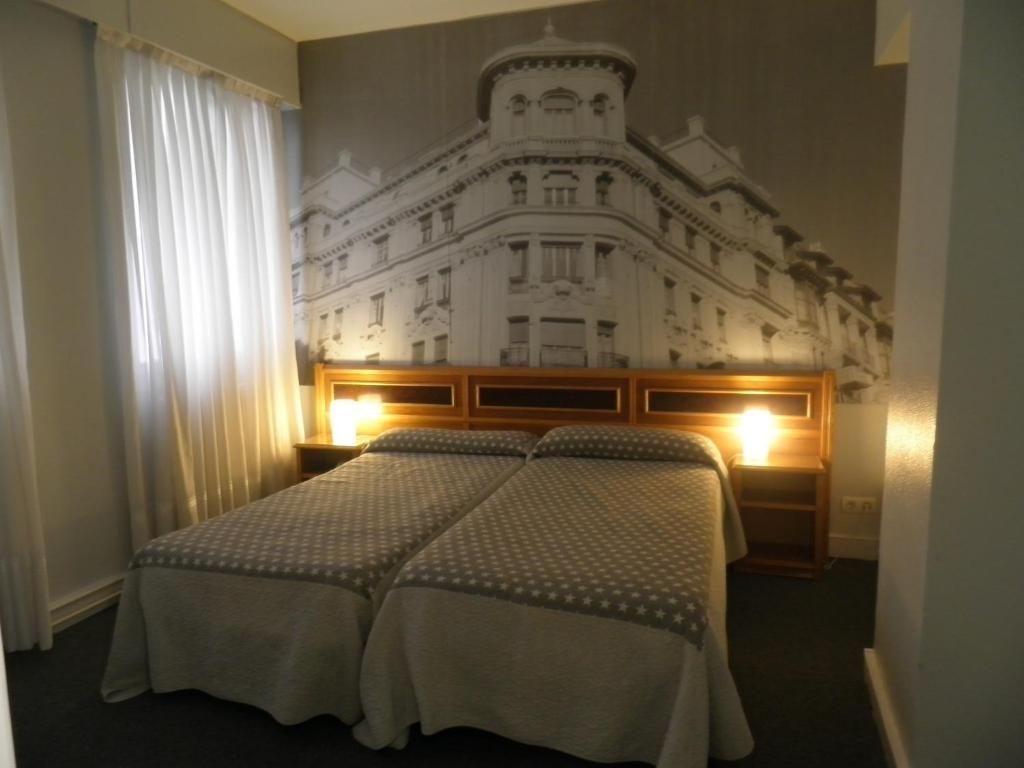 Postel nebo postele na pokoji v ubytování Hotel Photo Zabalburu