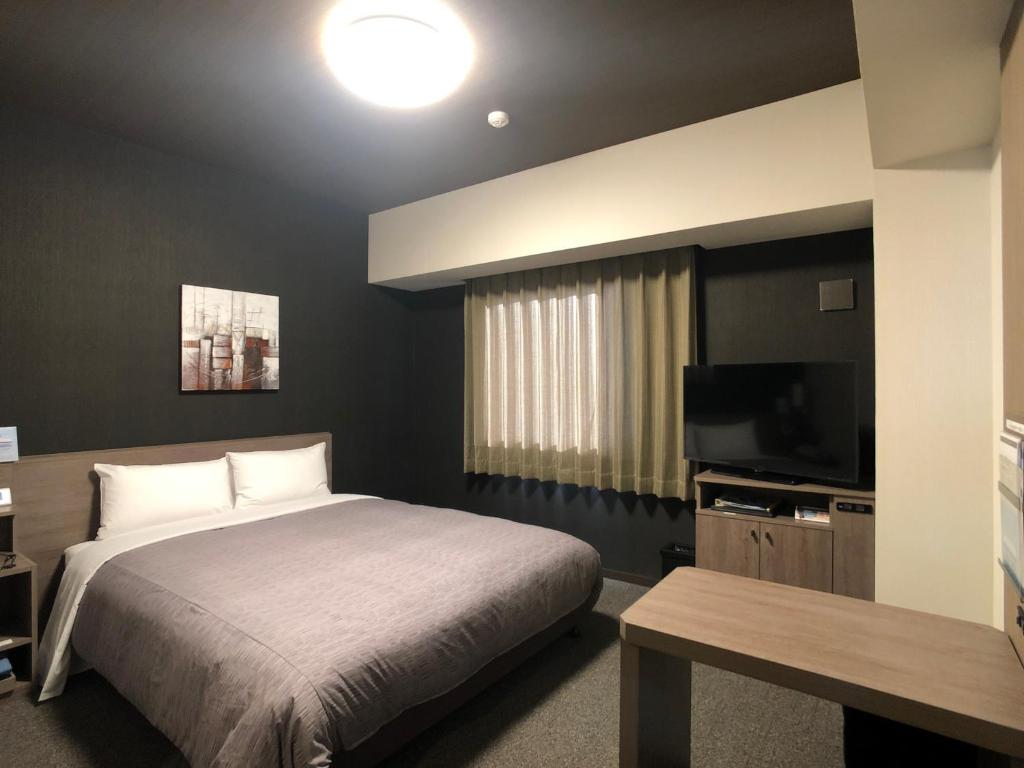 Postel nebo postele na pokoji v ubytování Hotel Route-Inn Tsuchiura