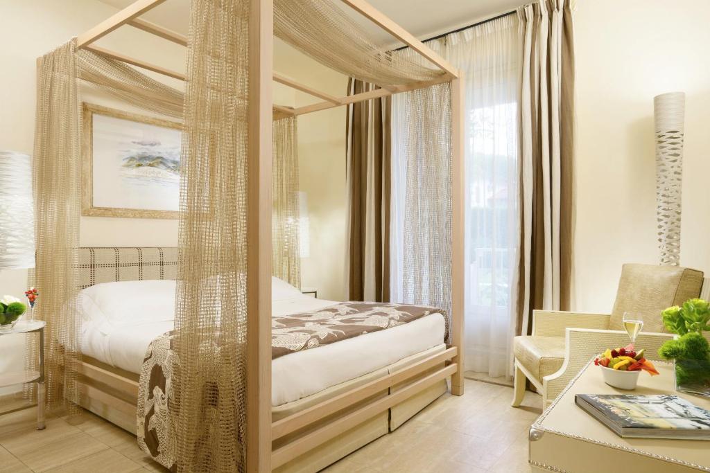 Postel nebo postele na pokoji v ubytování Villa Roma Imperiale
