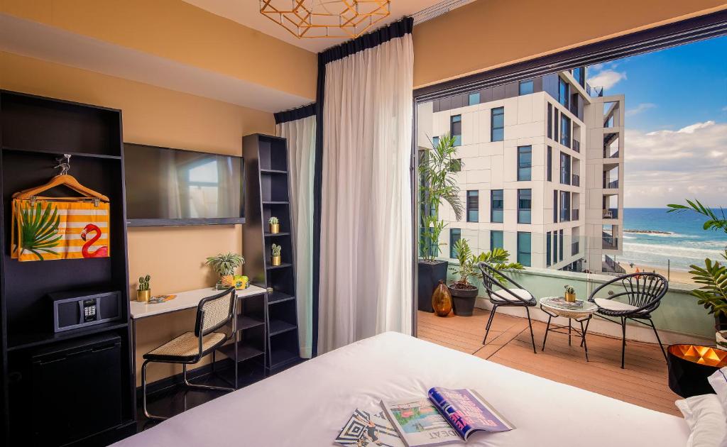 a bedroom with a bed and a view of the ocean at Brown Beach House Tel-Aviv, a member of Brown Hotels in Tel Aviv