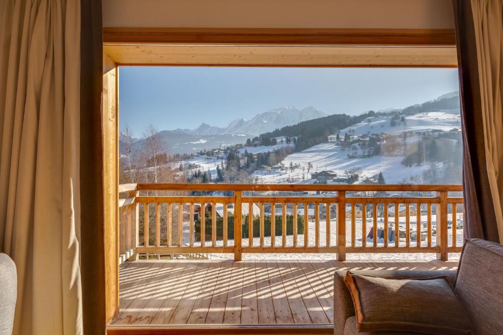 a balcony with a view of a snowy mountain at TERRESENS - Les Fermes du Mont-Blanc in Combloux