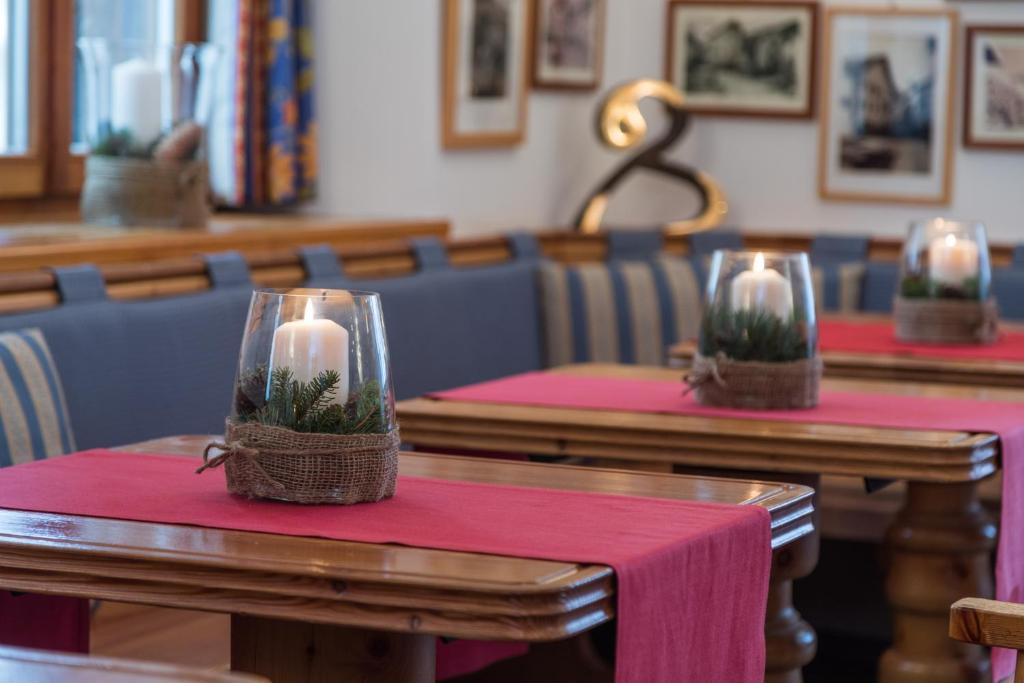 a row of tables with candles on top of them at Hotel Klarer in Zuoz