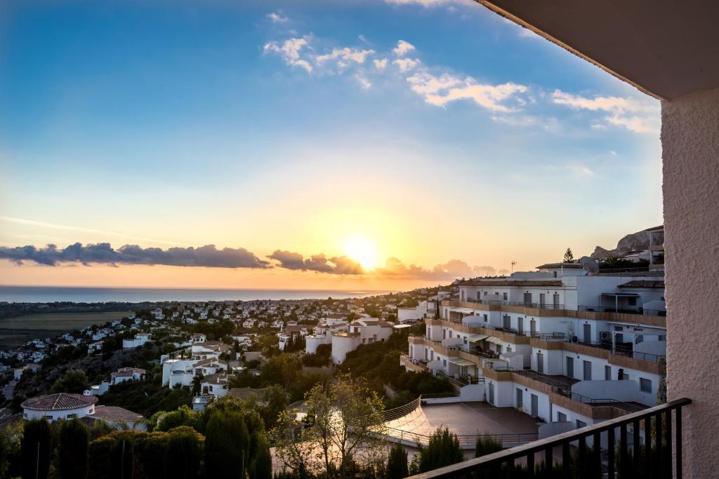 a view of a city at sunset from a building at Complejo Bellavista Residencial in Pego