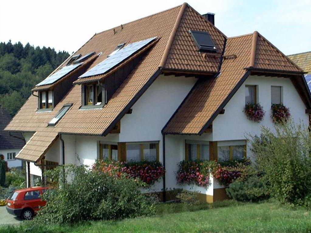 a house with a roof with solar panels on it at Ferienhof Huber in Oberkirch