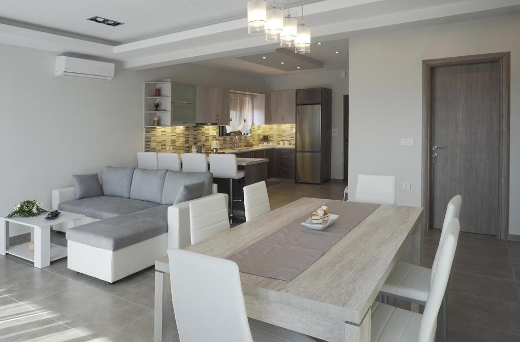a kitchen and living room with a table and a couch at Anastasia's Luxury Apartments in Chania Town