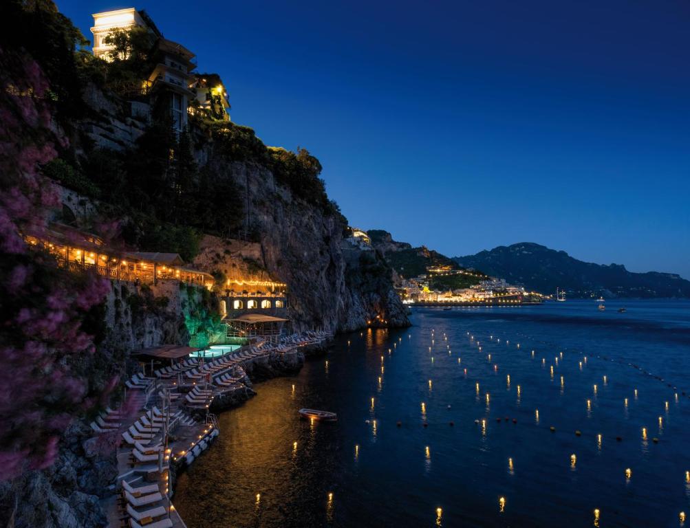 a view of a river at night with lights on a cliff at Hotel Santa Caterina in Amalfi