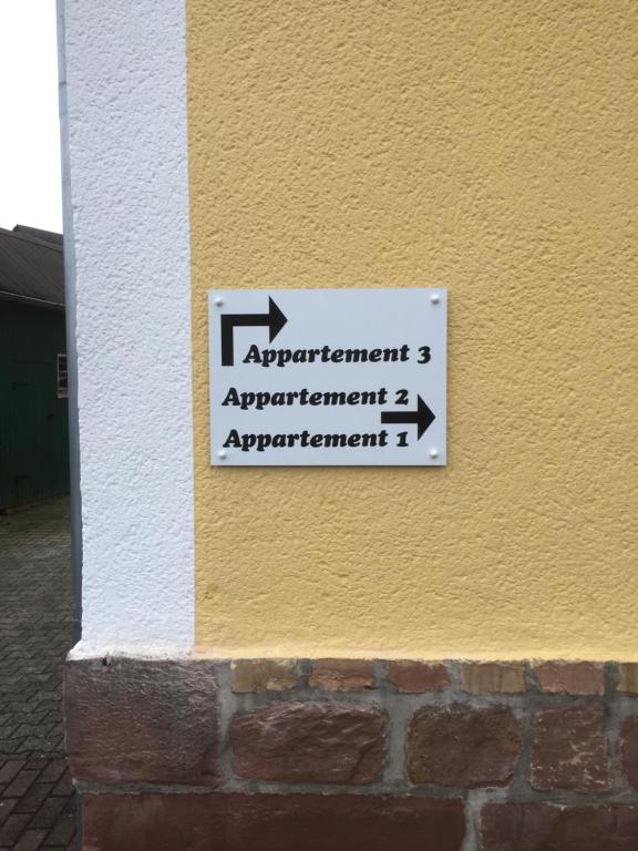 a sign on the side of a building that says experiment agreement and agreement at Knüllhotel Tann-Eck in Knüllwald