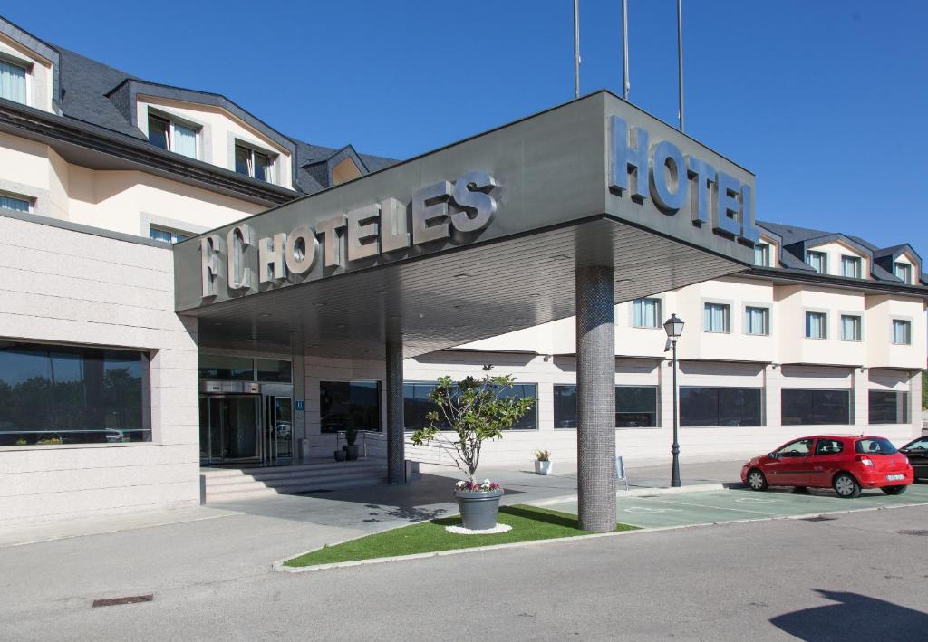 a building with a sign for a hotel at Hotel FC Villalba in Collado-Villalba