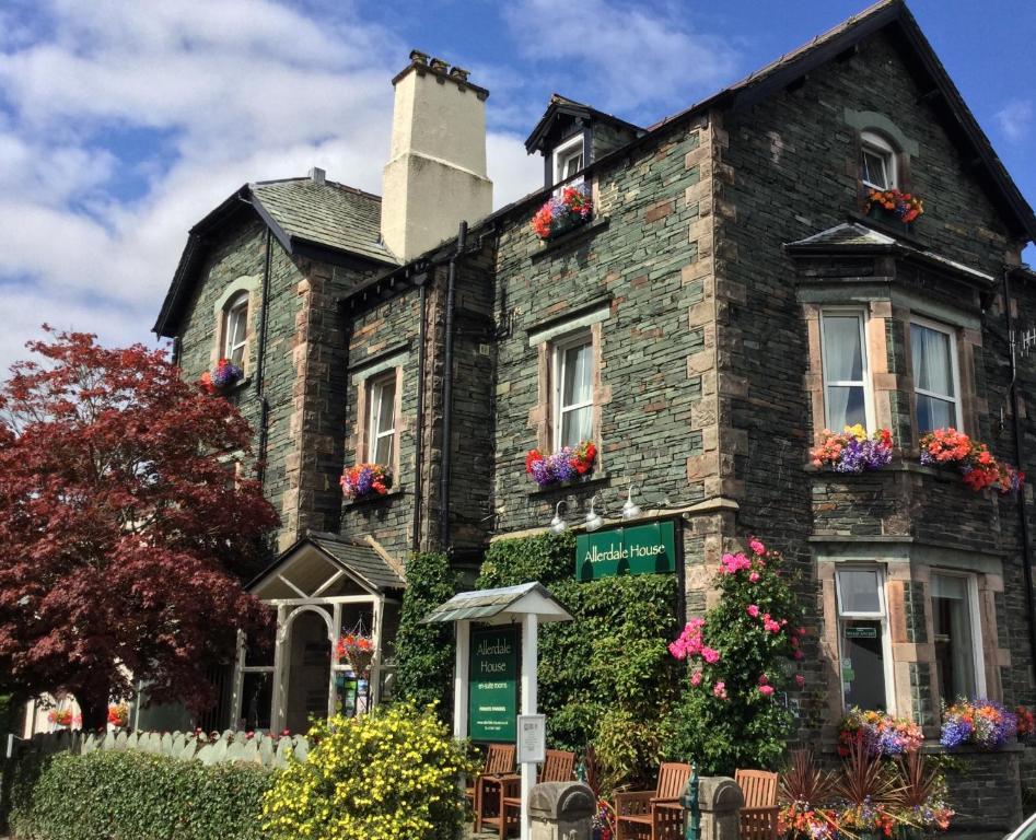 an old brick house with flowers on the windows at Allerdale Guest House in Keswick