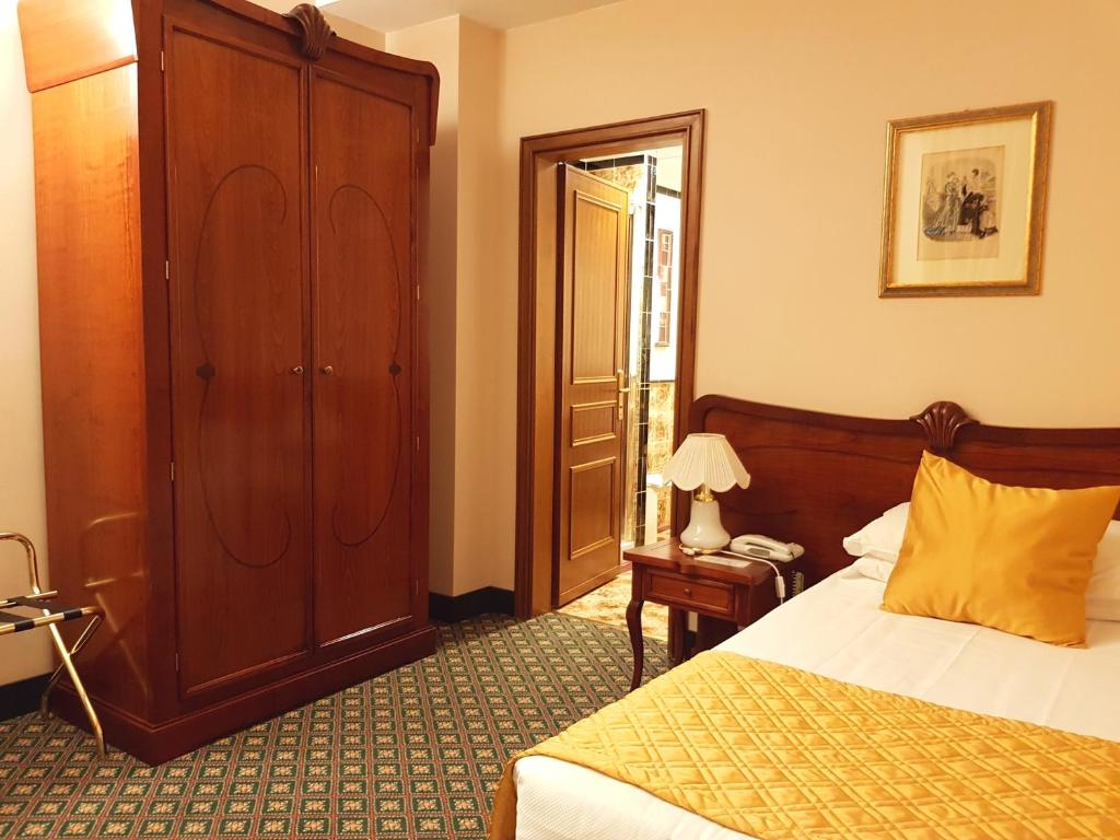 Postel nebo postele na pokoji v ubytování Hotel Berchielli