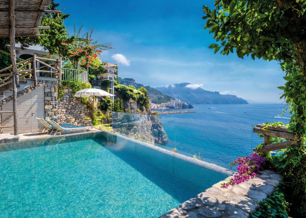 a swimming pool with a view of the ocean at Hotel Santa Caterina in Amalfi