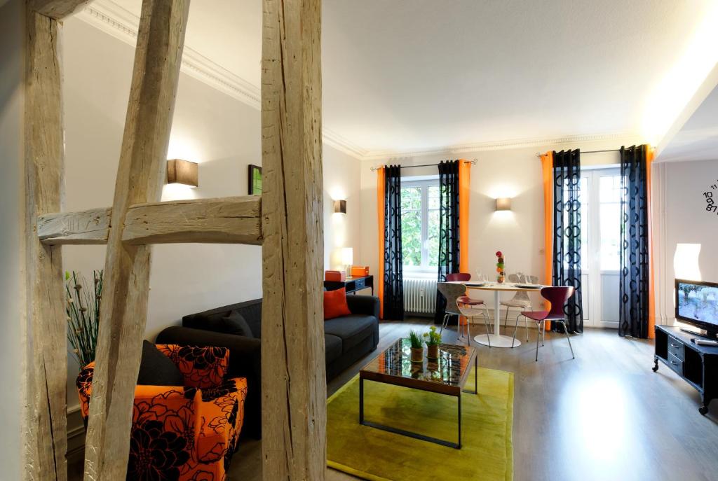 sala de estar con cama elevada y sofá en Les Balcons du Rohan, en Saverne