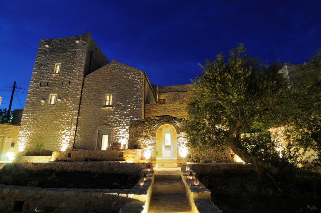 a large stone building with a tree in front of it at Antares Mani in Areopoli