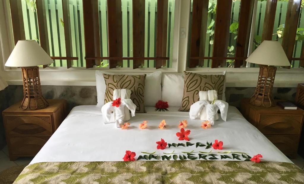 two elephants on a bed with flowers on it at Young Island Resort in Kingstown