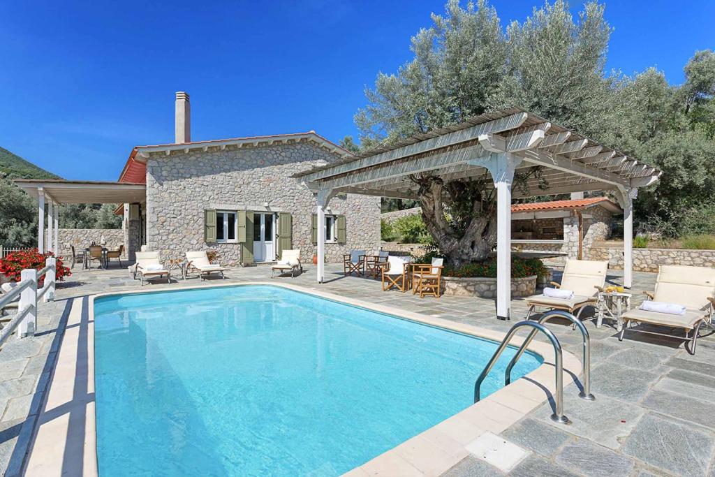 een zwembad voor een huis bij Villa Leda in Sivota