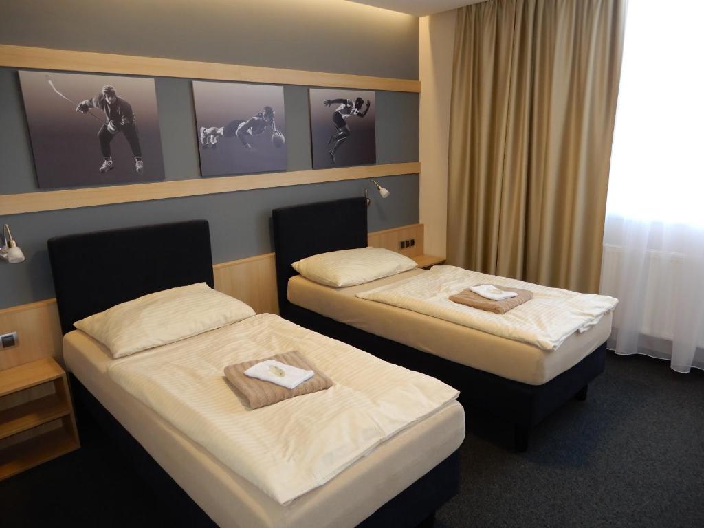 a hotel room with two beds with towels on them at OtavArena in Písek