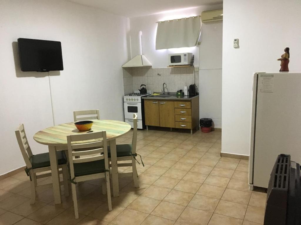 a kitchen and dining room with a table and chairs at Nueva Era Apart in La Consulta