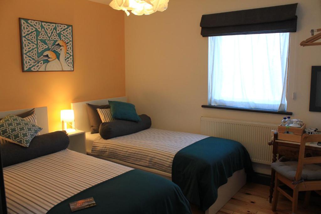 Letto o letti in una camera di Uisce Beatha House B&B