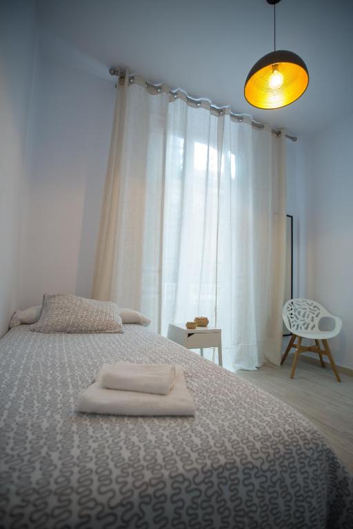 Posteľ alebo postele v izbe v ubytovaní Apartamentos Catedral