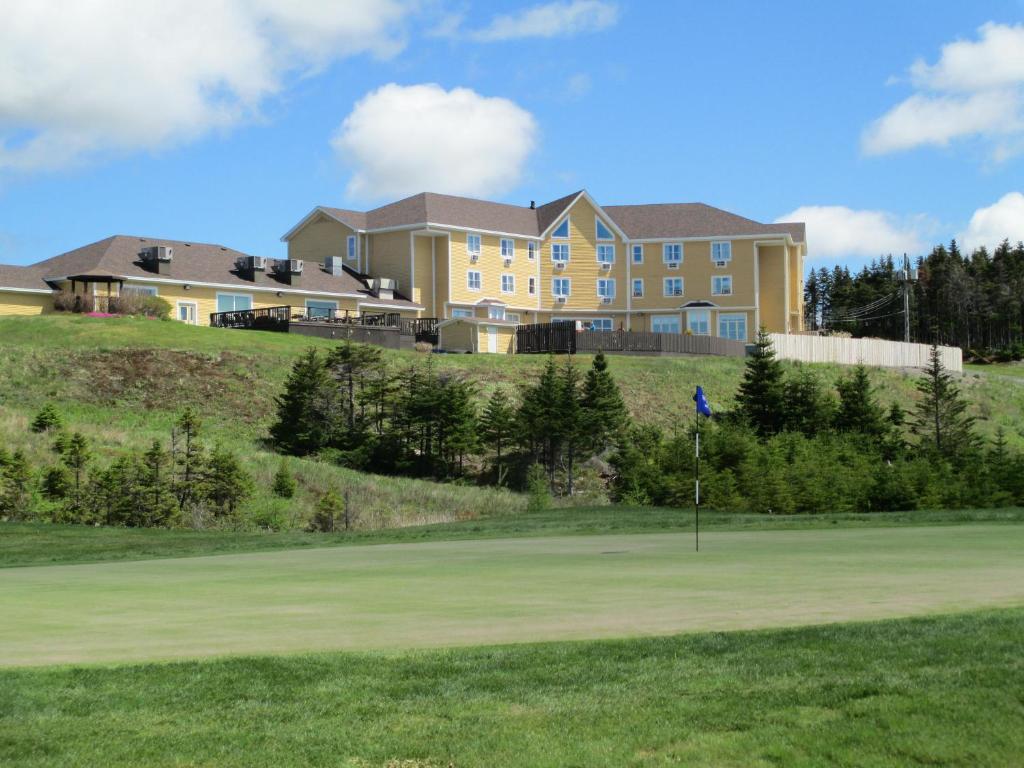 a house on top of a hill with a putting green at The Wilds at Salmonier River in Holyrood