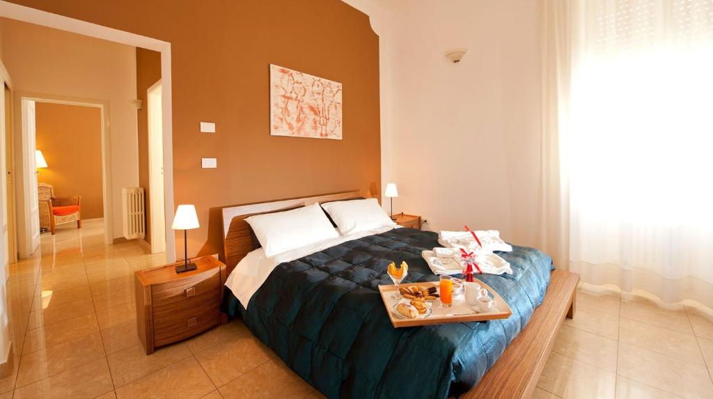 a bedroom with a bed with a tray of food on it at FourSeasons in Lecce
