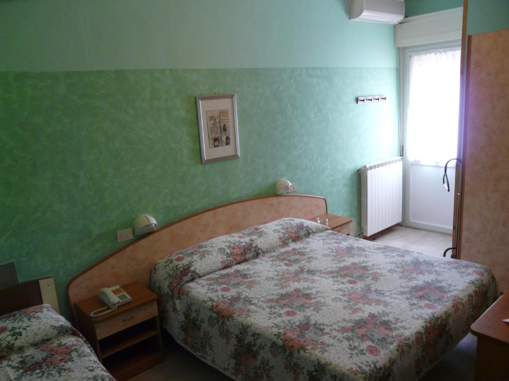 Postel nebo postele na pokoji v ubytování Hotel Vecchia Rimini
