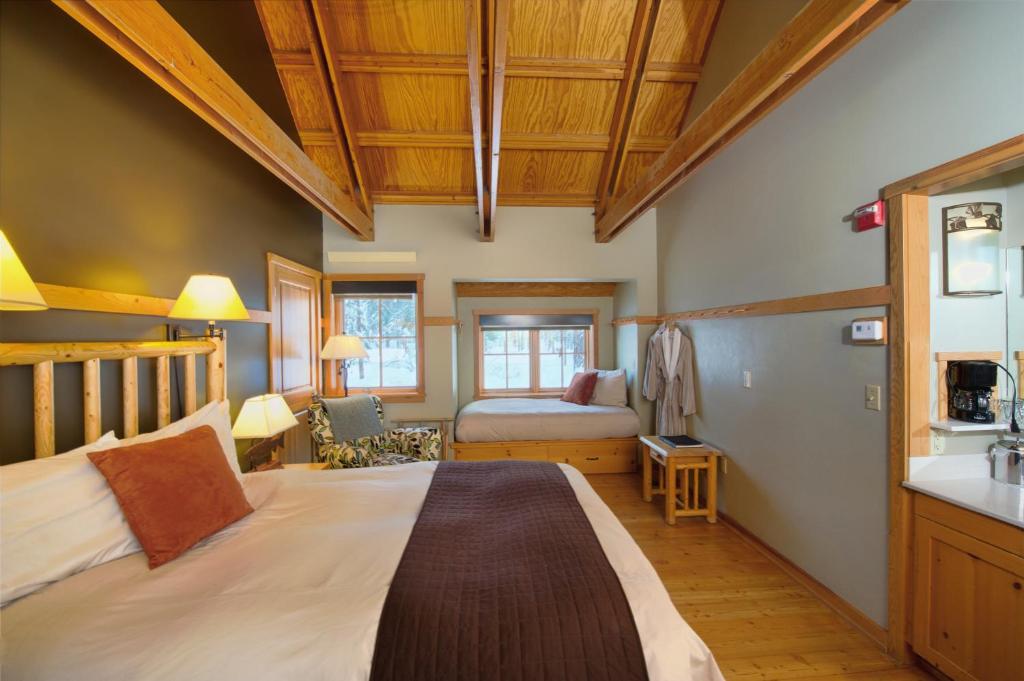 a bedroom with a bed and a sink in a room at Sleeping Lady Mountain Resort in Leavenworth