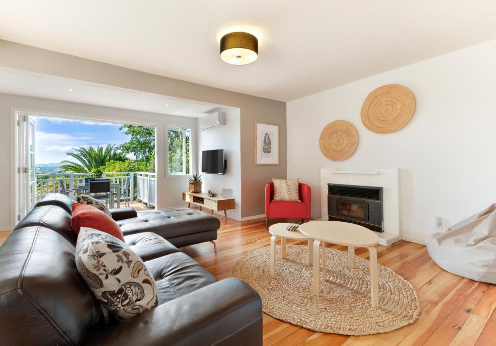 a living room with a couch and a table at Eight on Church - near Mudbrick & Cable Bay in Oneroa