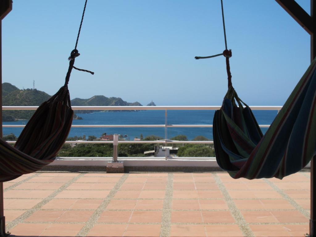 a pair of hammocks overlooking the ocean at Casa Luna Hotel in Taganga