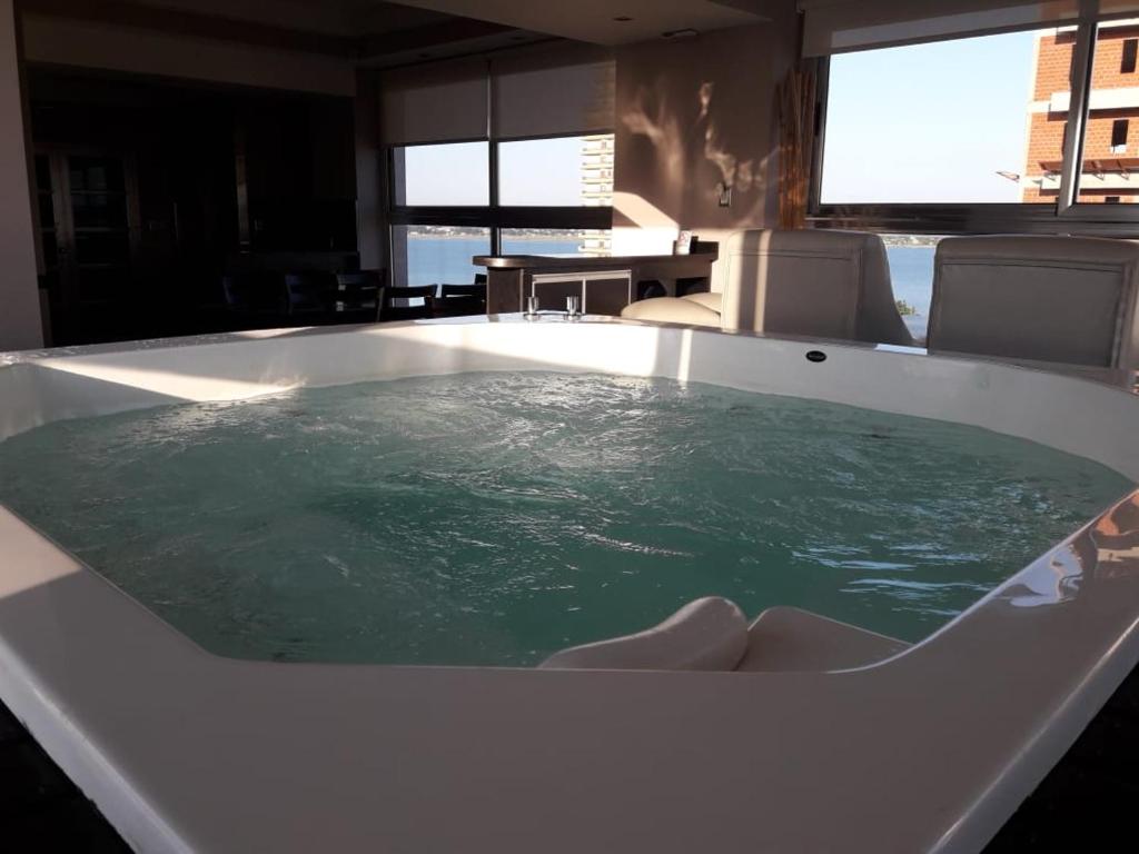 a bath tub filled with green water in a room at Apart Belgrano in Posadas