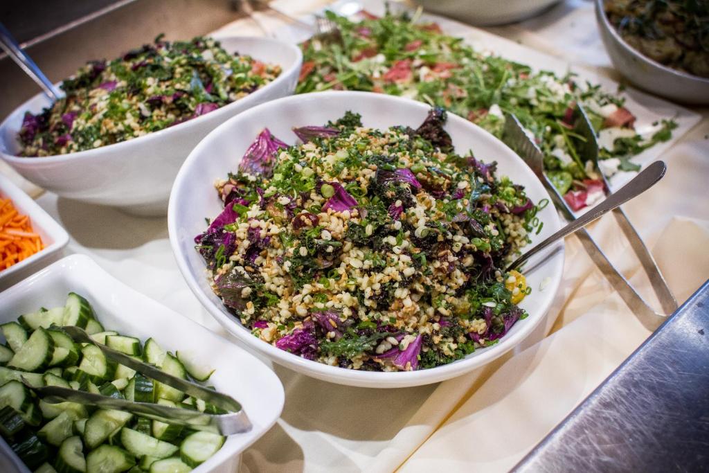 a table topped with bowls of salads and vegetables at Sleeping Lady Mountain Resort in Leavenworth