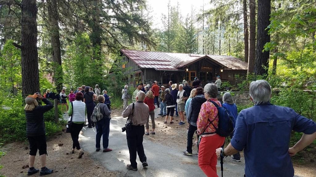 a large group of people walking in the forest at Sleeping Lady Mountain Resort in Leavenworth