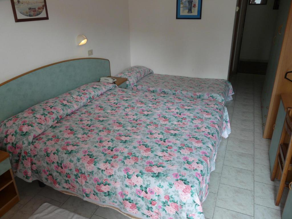 Postel nebo postele na pokoji v ubytování Hotel Vecchia Rimini