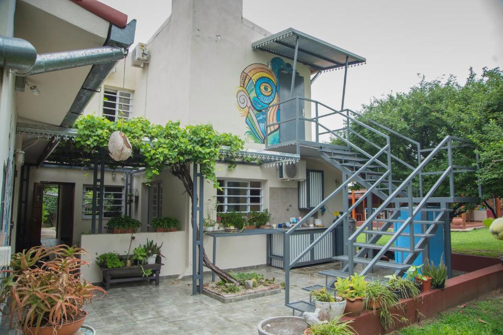 a house with a spiral staircase in the yard at Feliza Hostel in Villa Carlos Paz