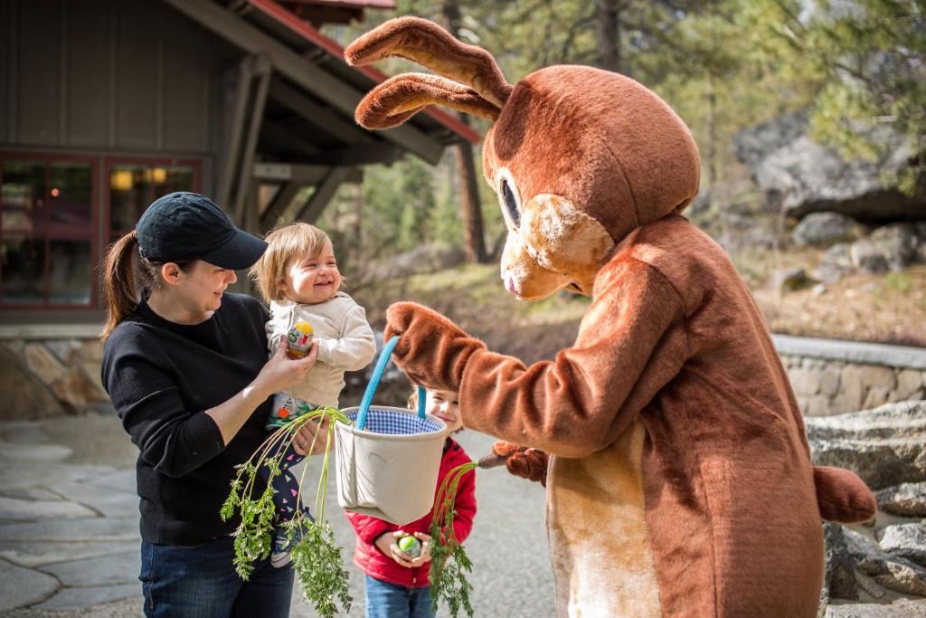 a woman in a bunny costume holding a little girl at Sleeping Lady Mountain Resort in Leavenworth