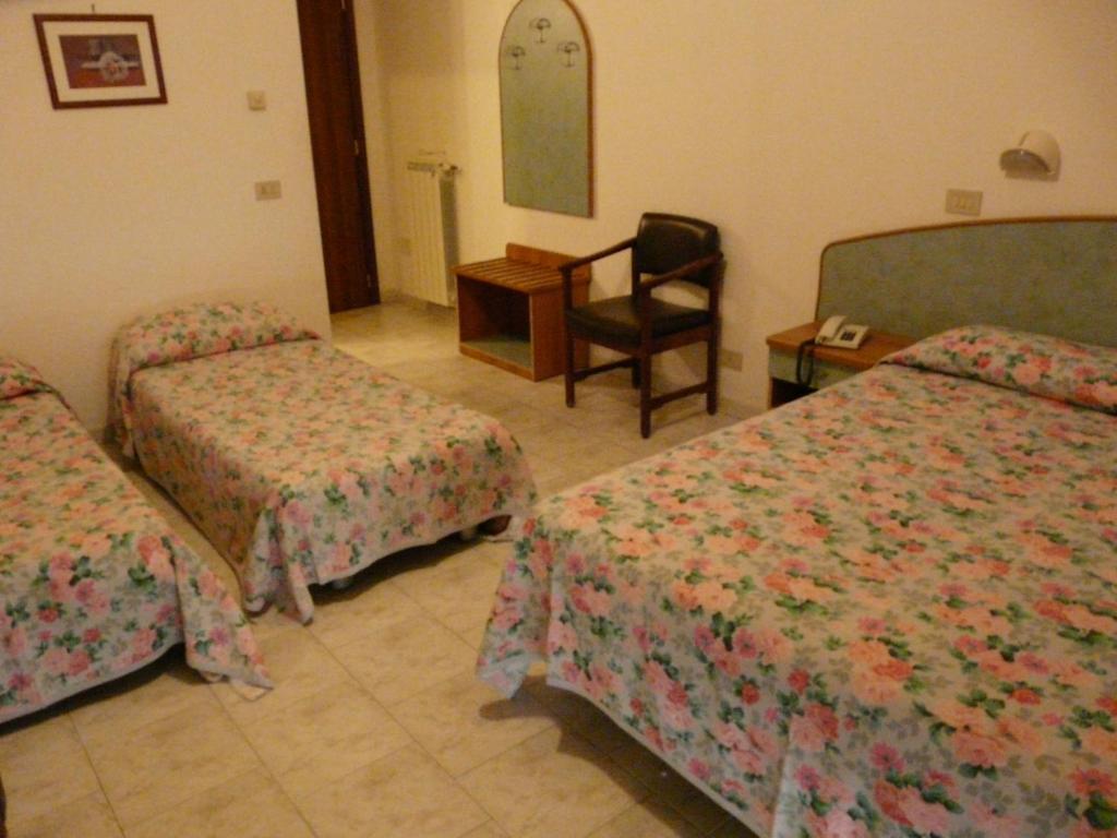 Postel nebo postele na pokoji v ubytování Hotel Vecchia Rimini