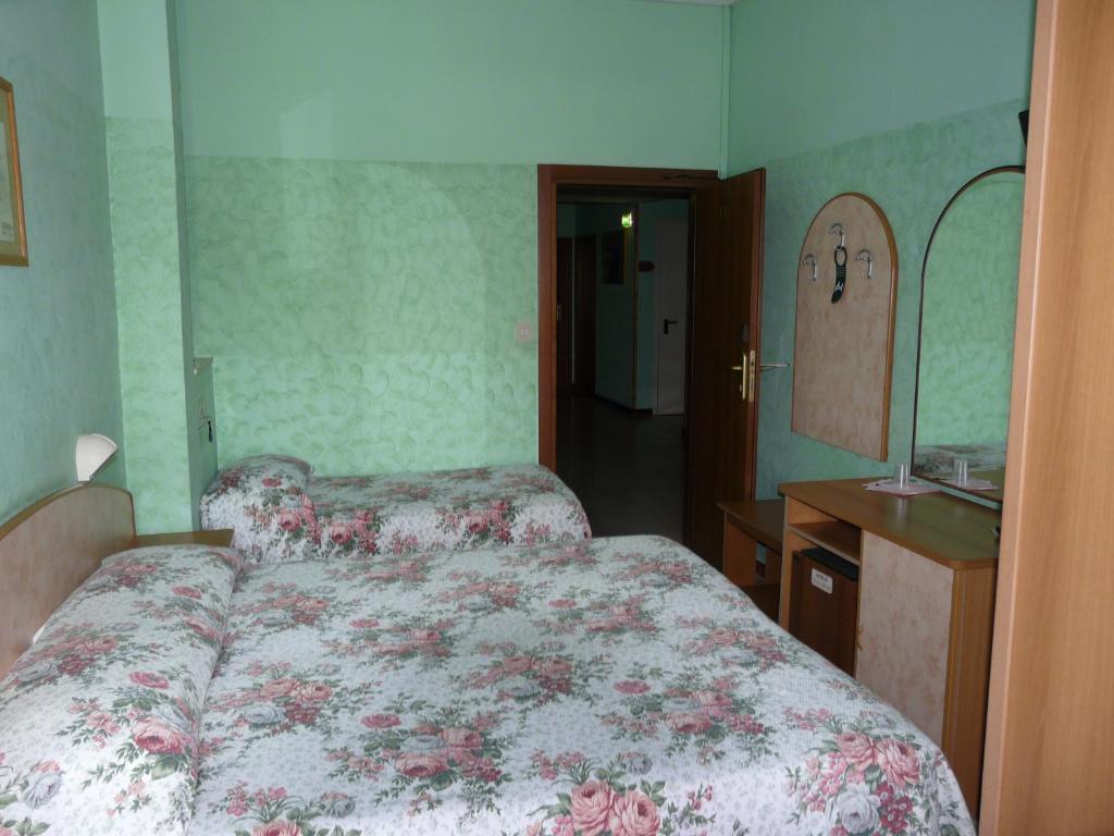 Postel nebo postele na pokoji v ubytování Hotel Vecchia Rimini