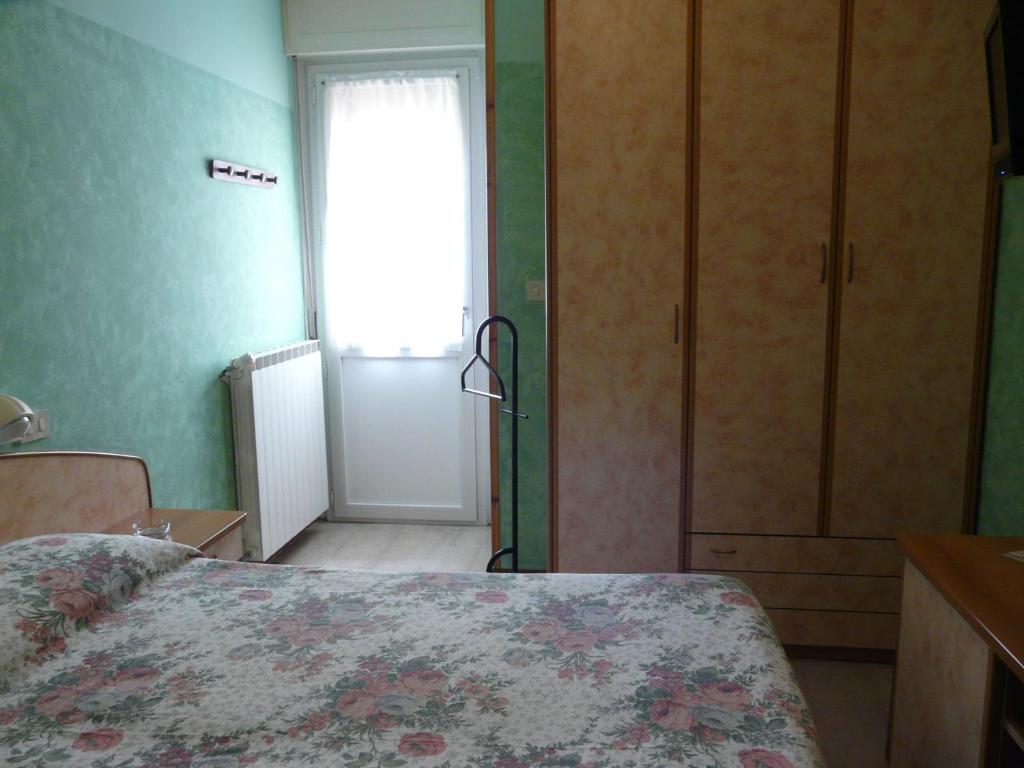 Postel nebo postele na pokoji v ubytování Hotel Vecchia Rimini