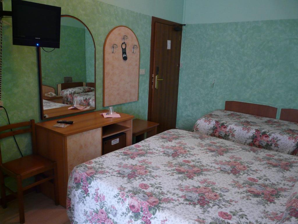 Postel nebo postele na pokoji v ubytování Hotel Vecchia Rimini