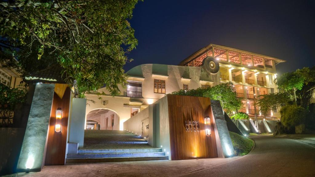 a building with lights on it at night at The Lady Hill Hotel in Galle