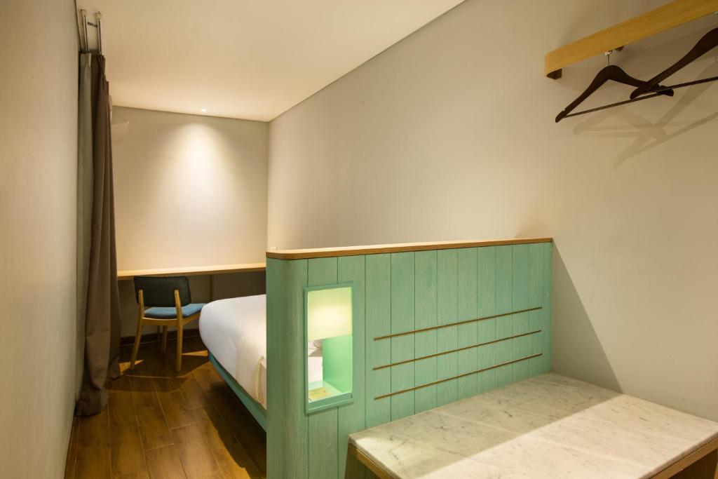 Postel nebo postele na pokoji v ubytování Hotel Santika Premiere Garut