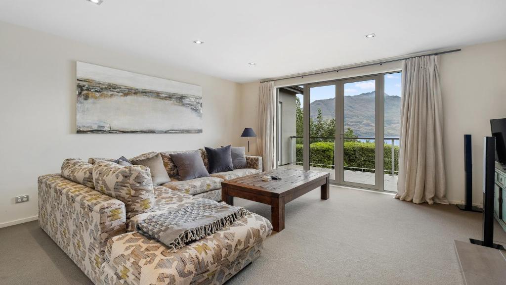 a living room with a couch and a table at Galway Court in Queenstown