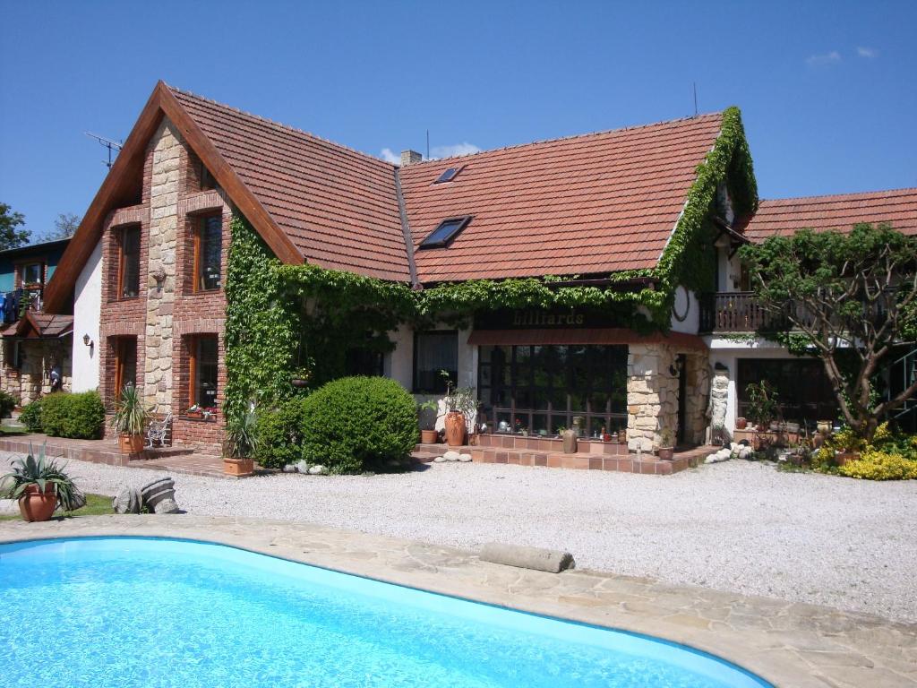 a house with a swimming pool in front of it at Penzion Prezident in Soběraz