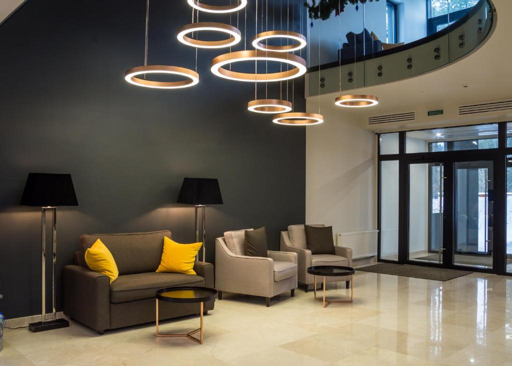 a lobby with couches and chairs and a chandelier at Sobi Hotel in Vyshhorod