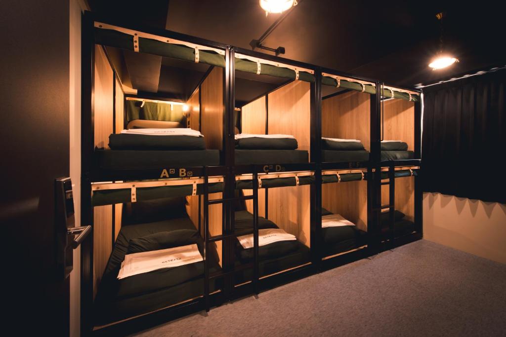 a group of bunk beds in a room at Getcha Hostel in Taichung