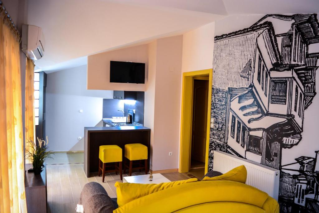 a living room filled with furniture and a painting on the wall at Di Angolo Apartments in Ohrid
